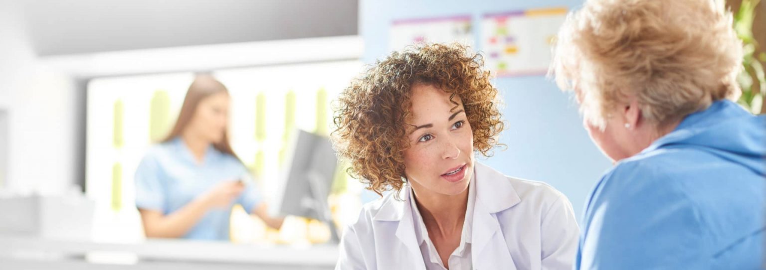 Doctor discussing voice disorders with patient.